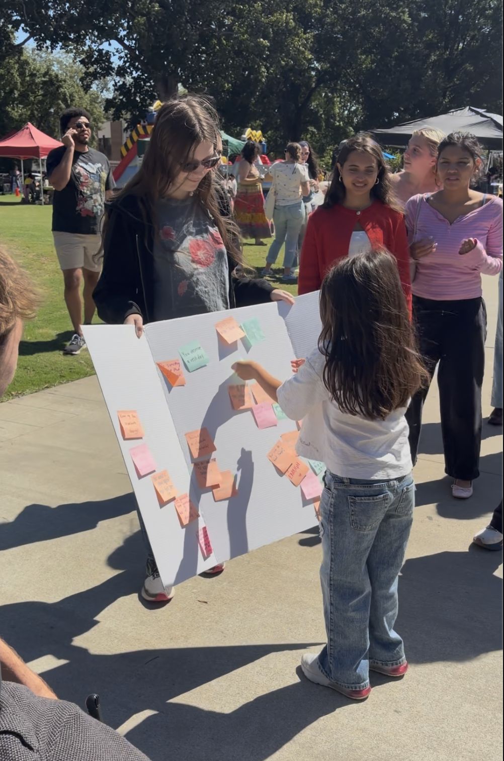 A child reading love notes on a board